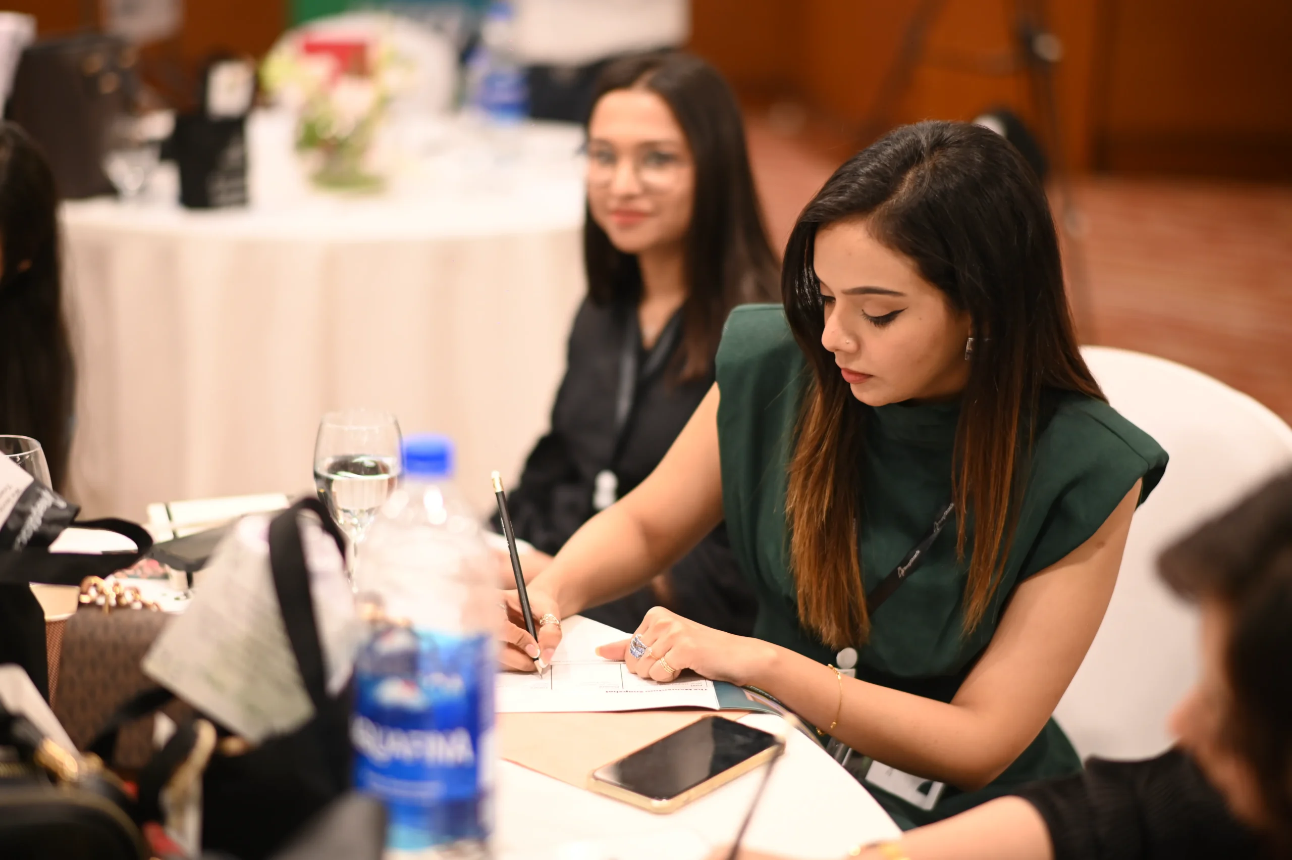 RepStack associates writing notes at a table during an event.