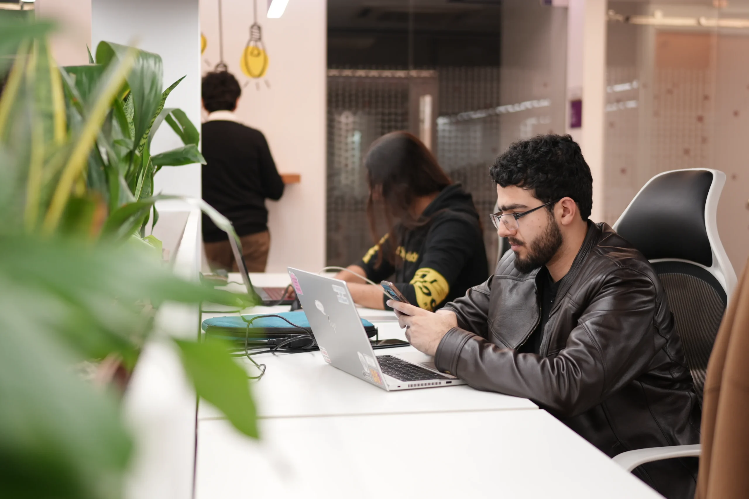 Employees working at desks in open office.