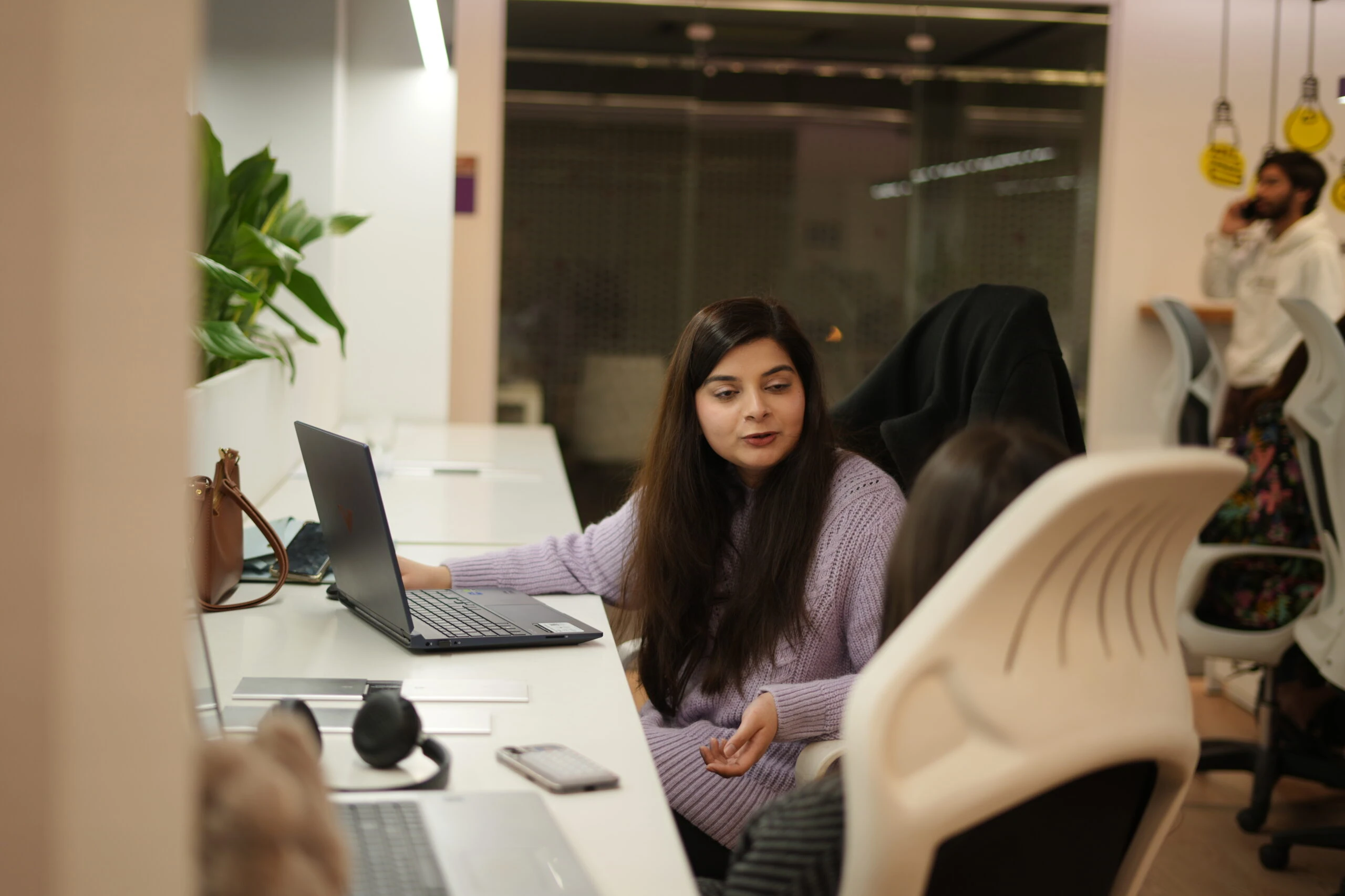 Employee working at desk in open office.